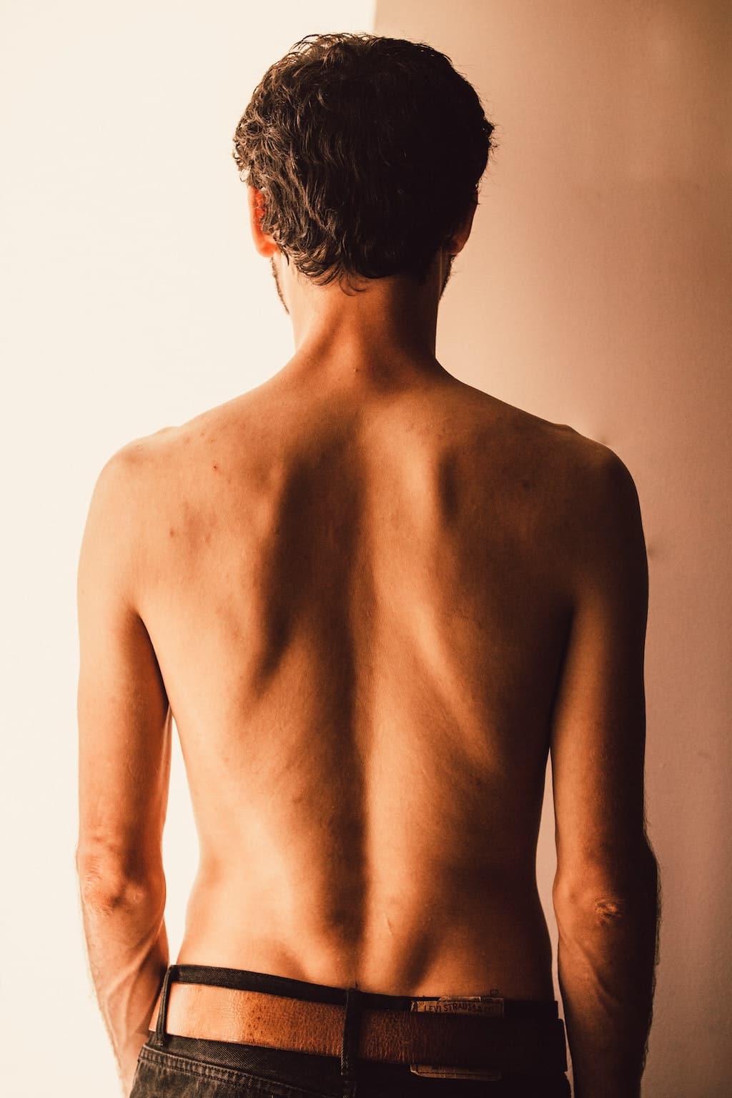 A photo of a woman's back standing straight