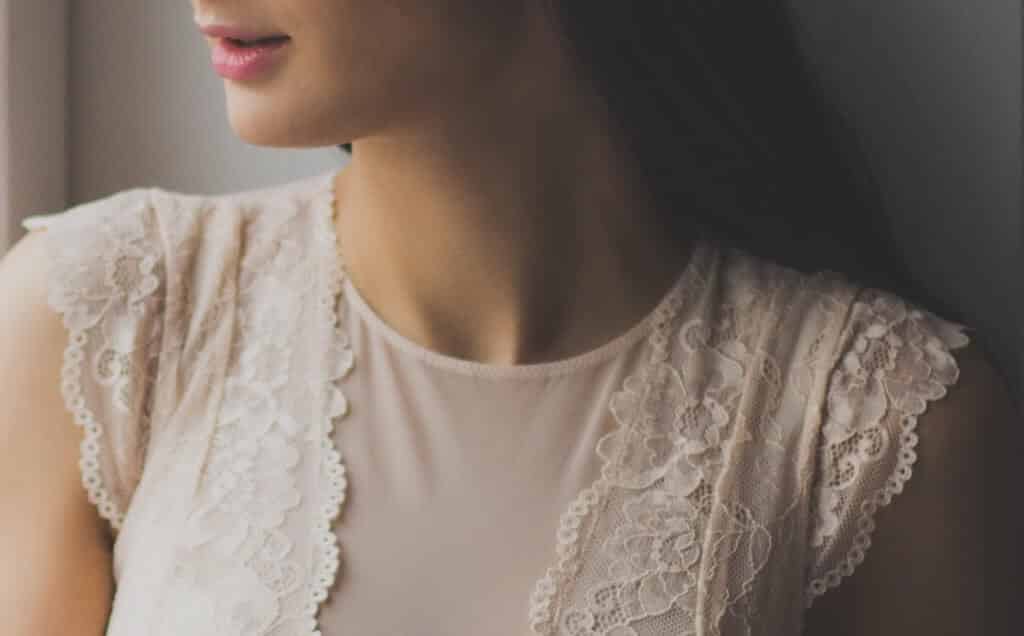 Photo of a woman's profile wearing a white shirt