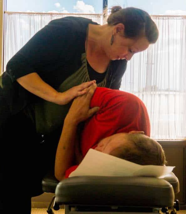 A chiropractic treatment happening on a treatment table