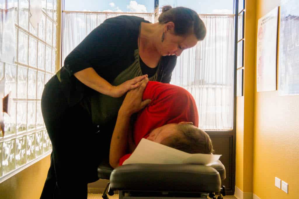 A chiropractic treatment happening on a treatment table