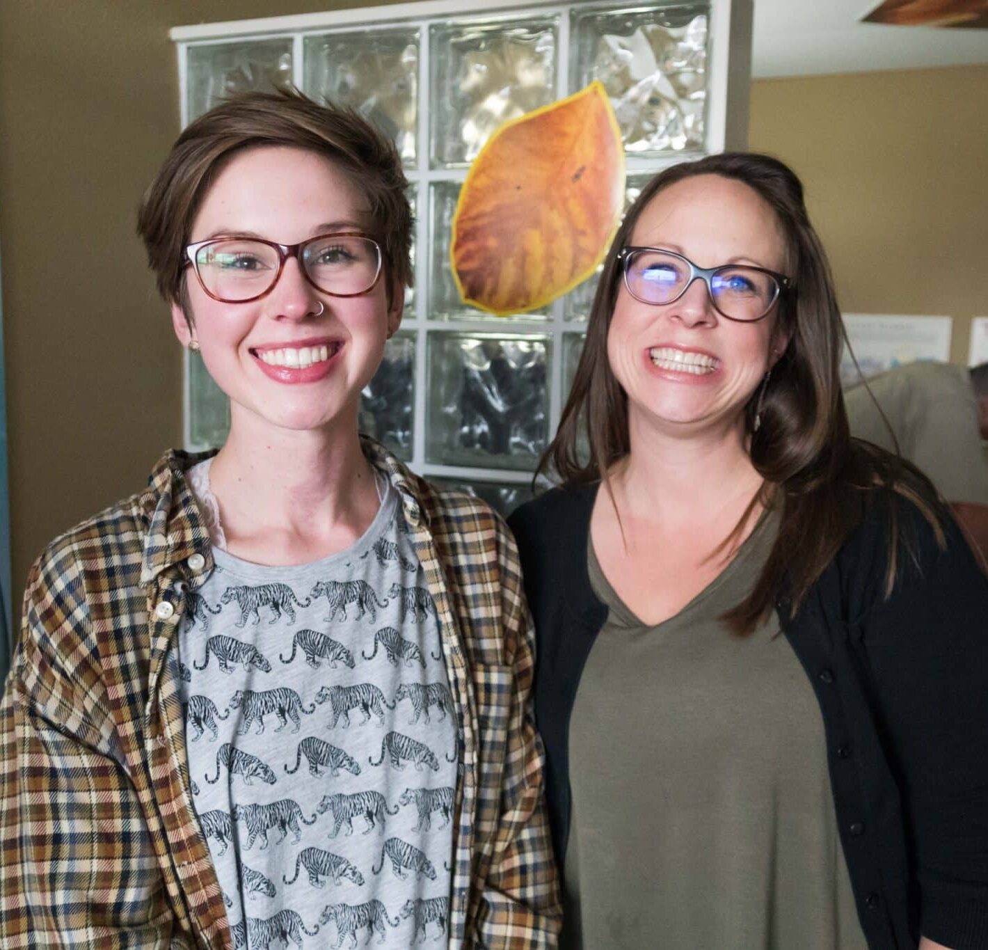 A photo of two people standing side by side with large smiles on their face