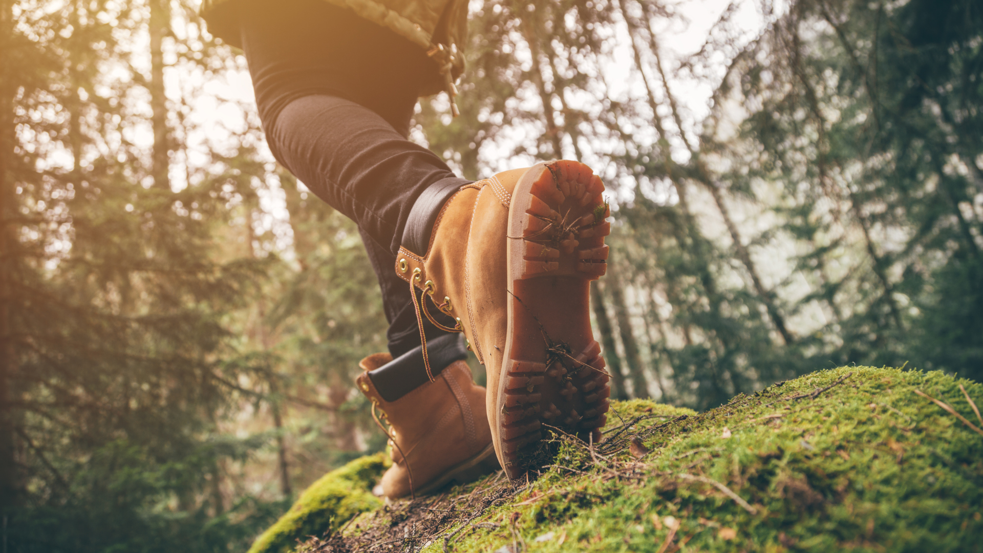 feet in boots hiking through woods